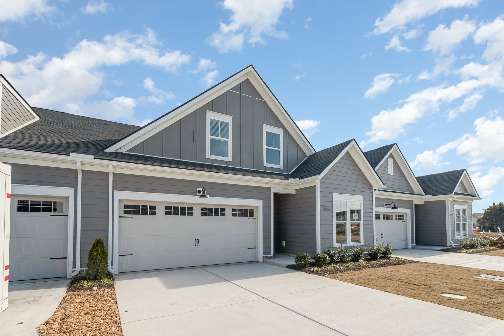 A side view of a gray cambridge home built by patterson company