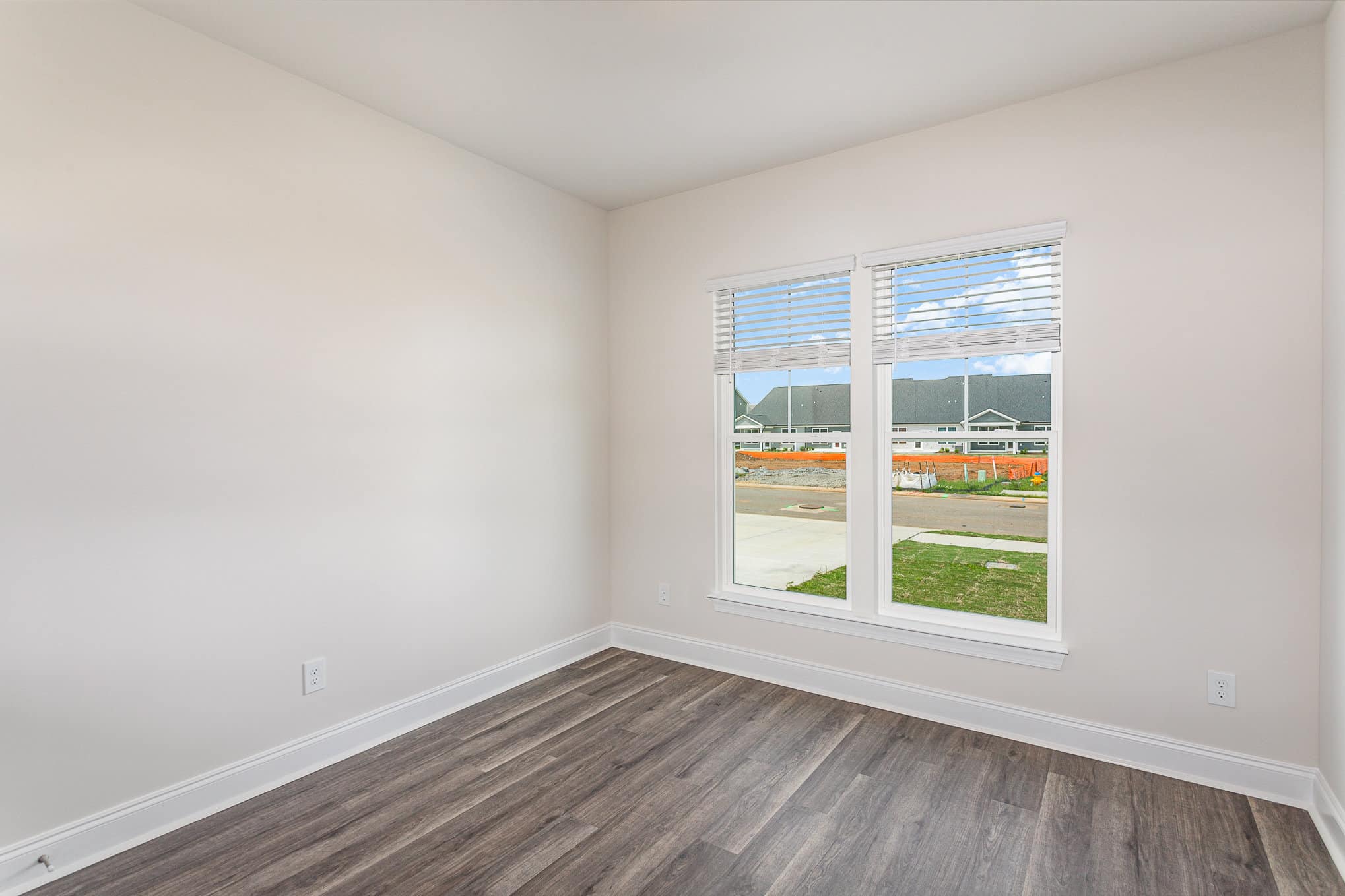 A white bedroom in a home built by patterson company