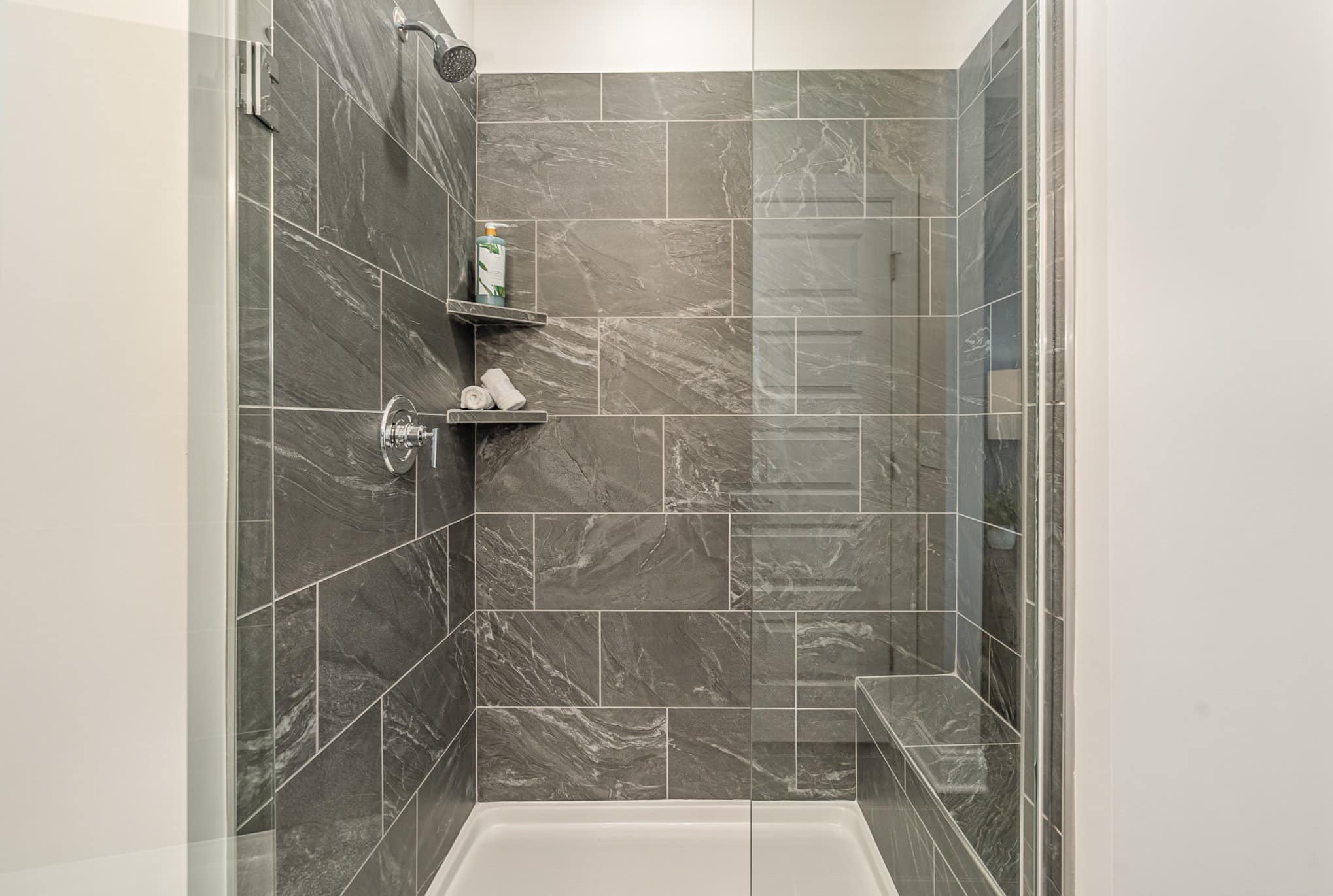 A walk in shower in a home built by patterson company