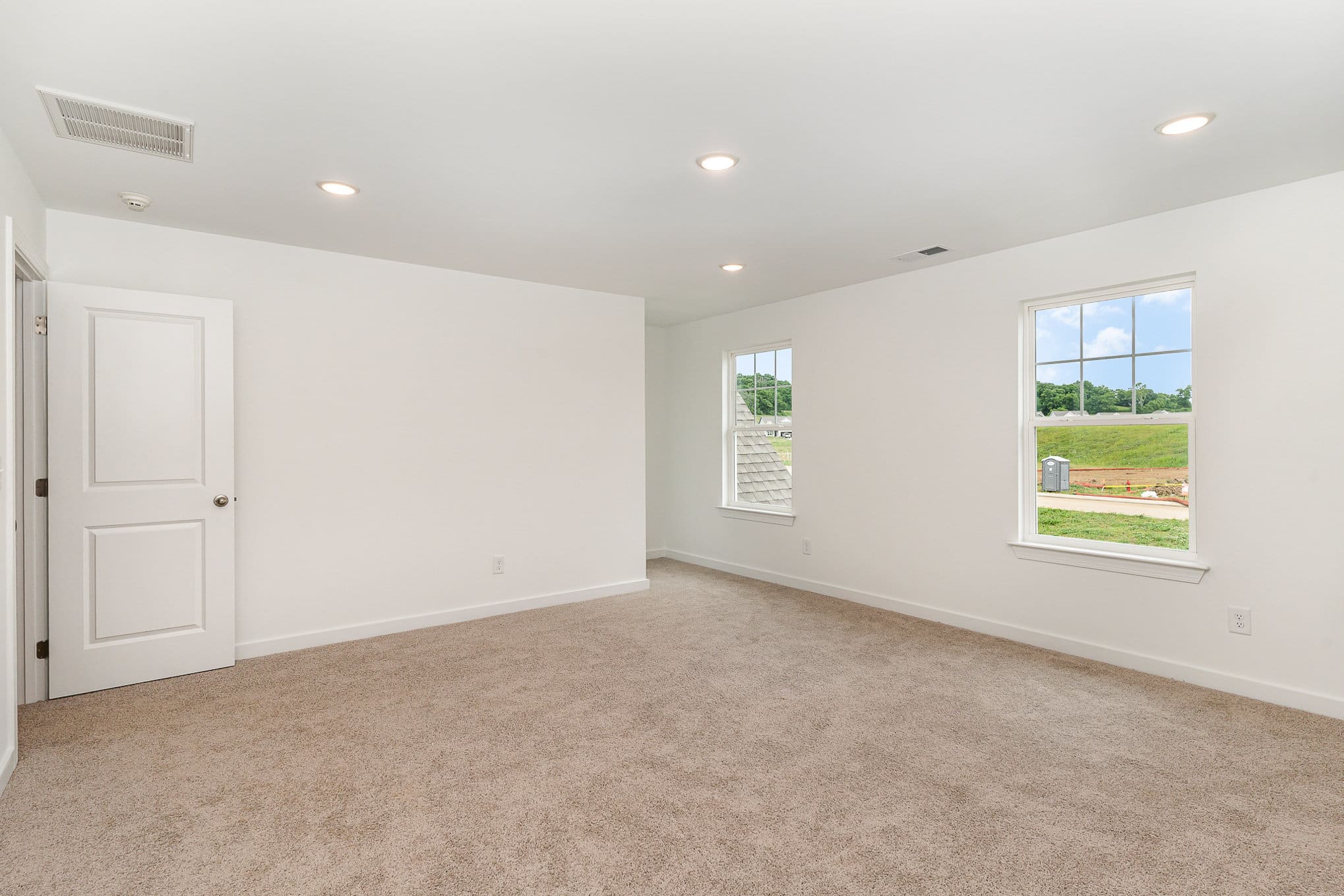 A large bedroom in a home built by patterson company