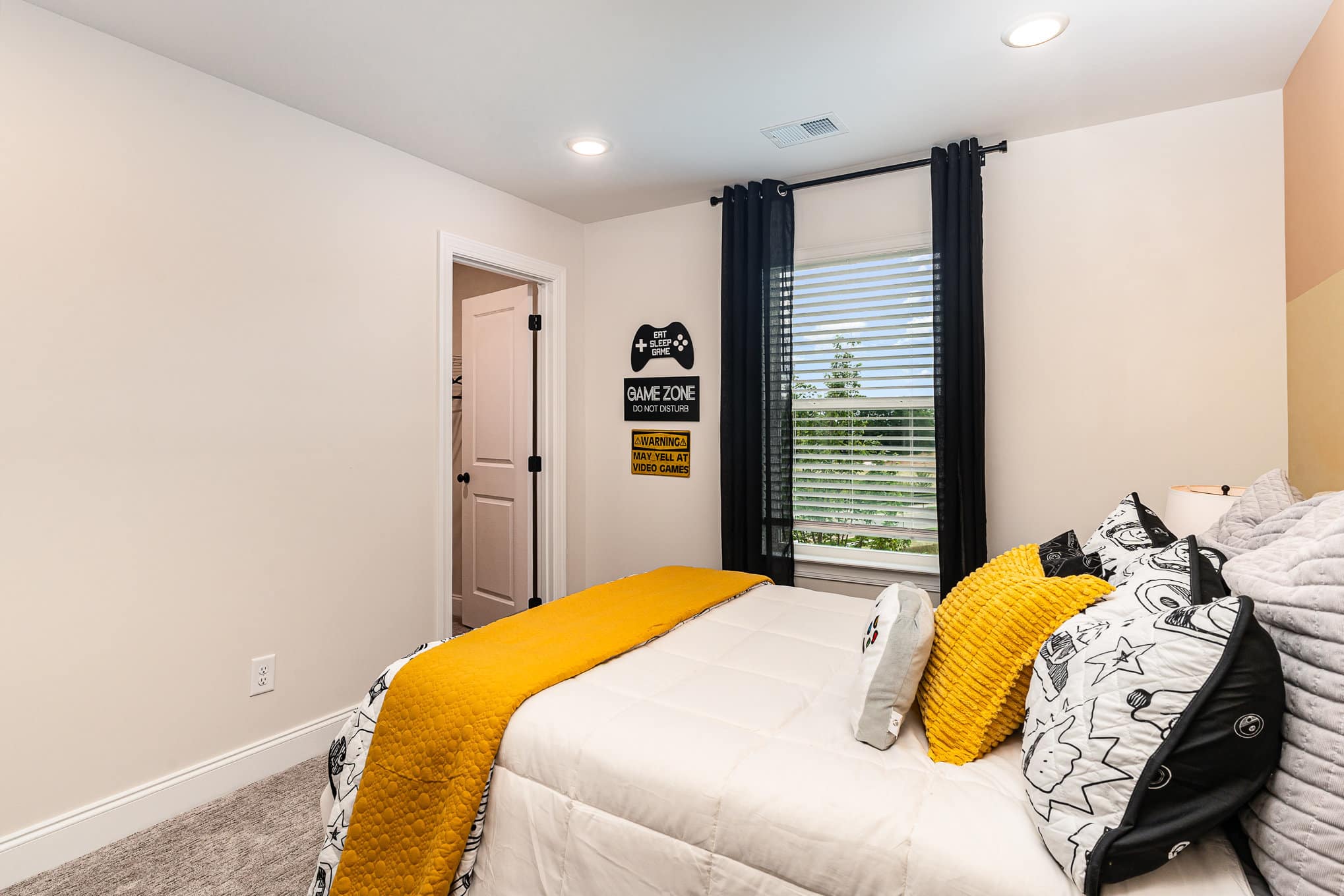 A boy's white walled bedroom in a home built by patterson company