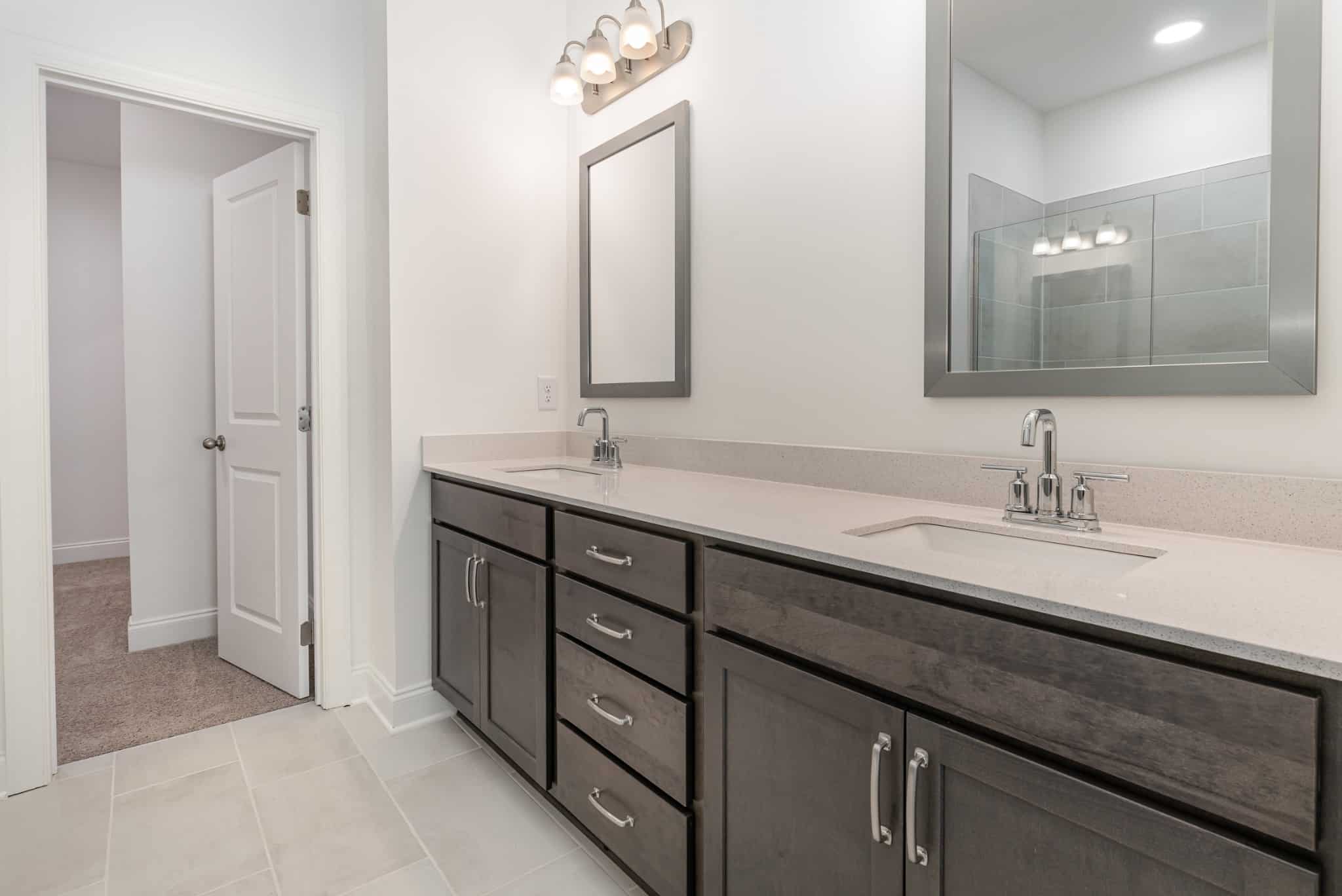 A dual sink bathroom in a home built by patterson company