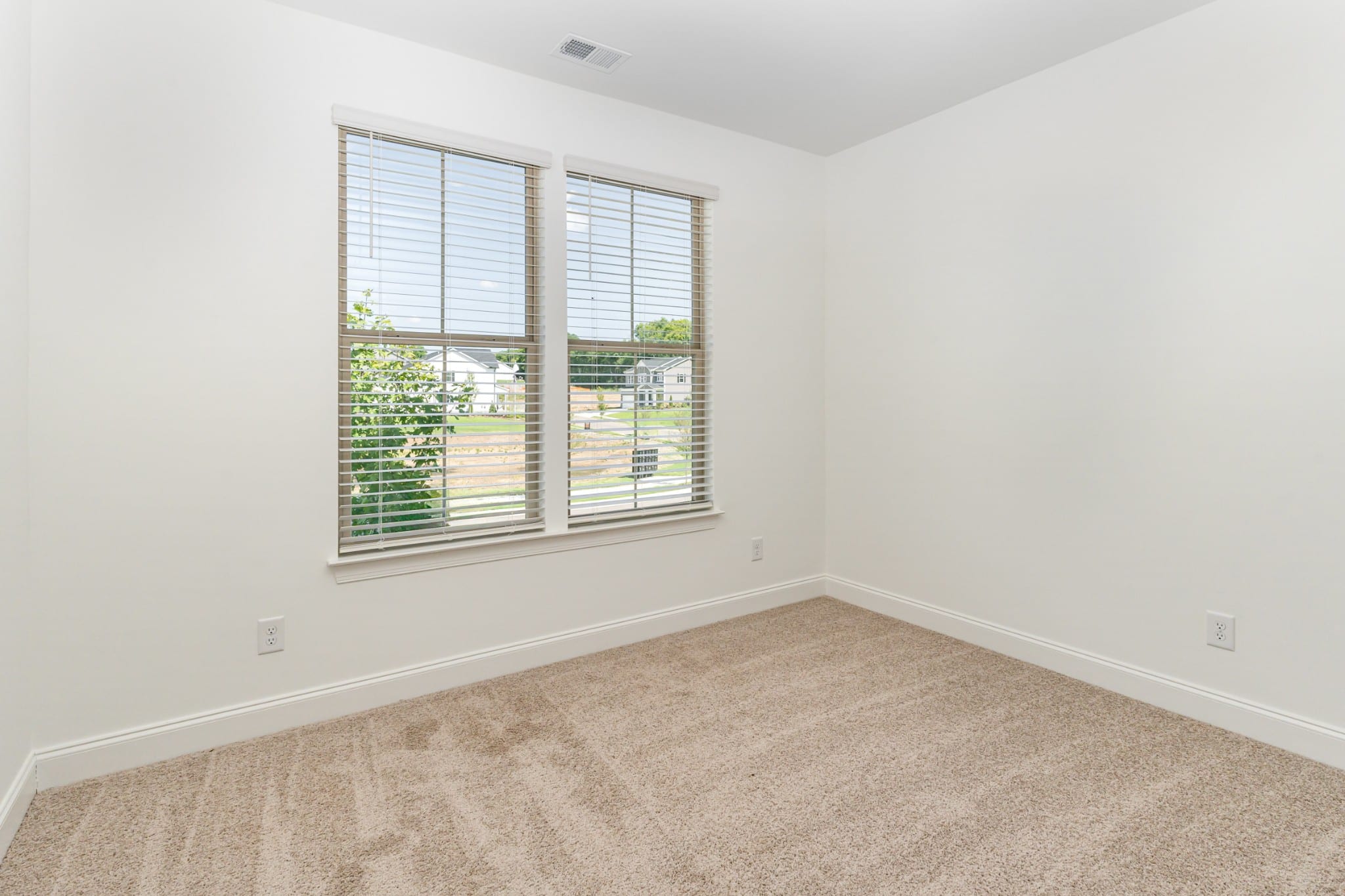 A bedroom window in a home built by patterson company