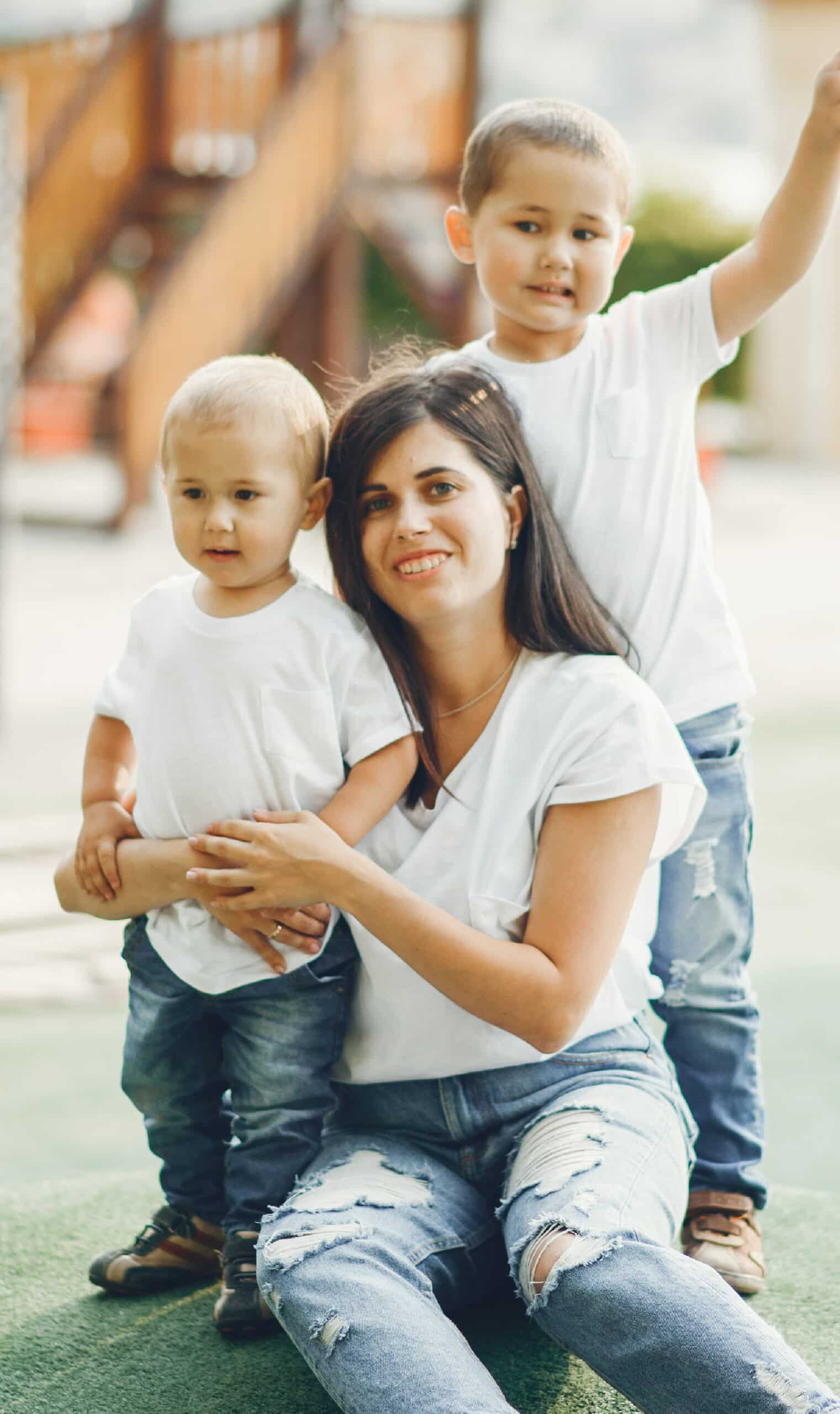 A mom and two sons at a playground in Arbor Valley