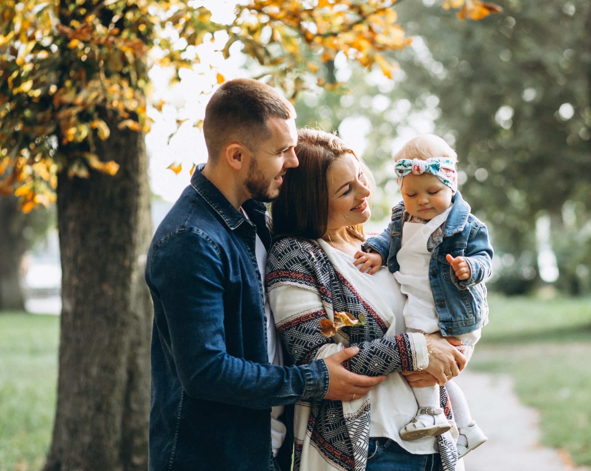A family of three on a sidewalk