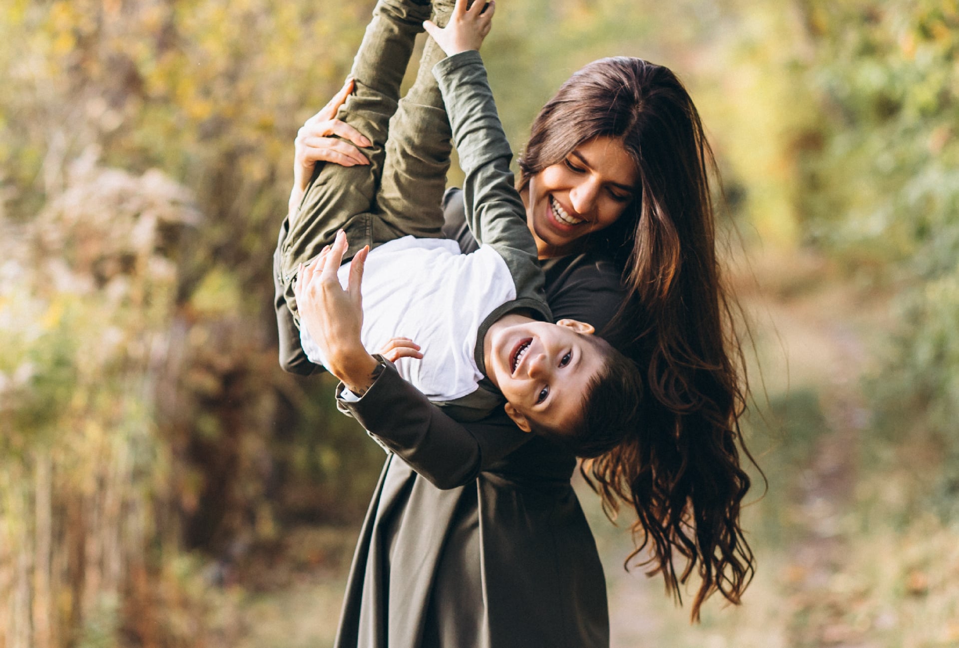 A mom and her son playing in the woods