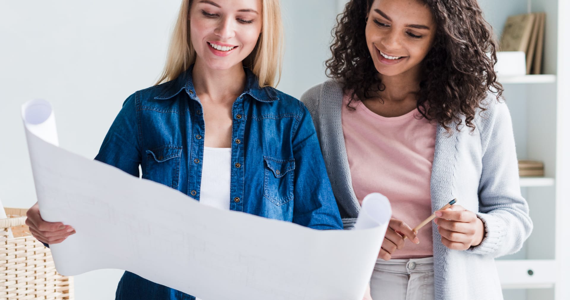 Two women looking over a plan