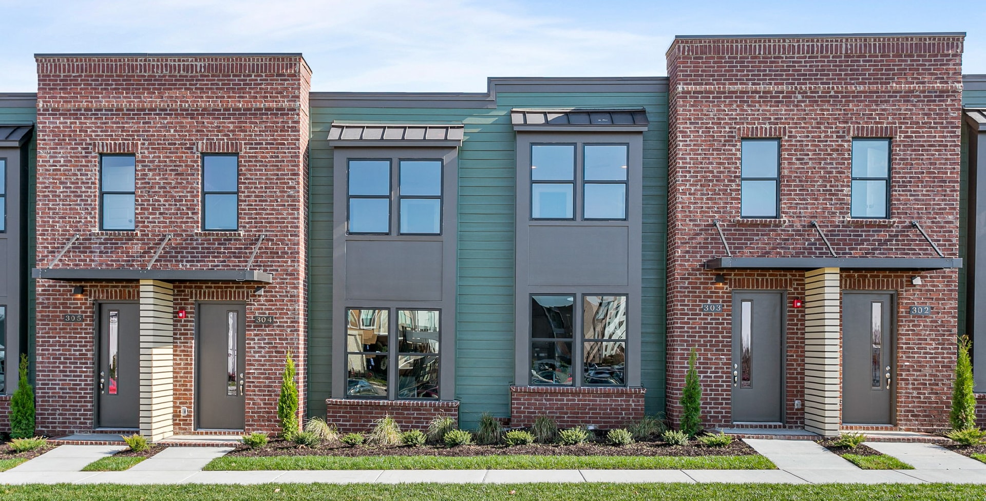 Green and brick condos built by Patterson