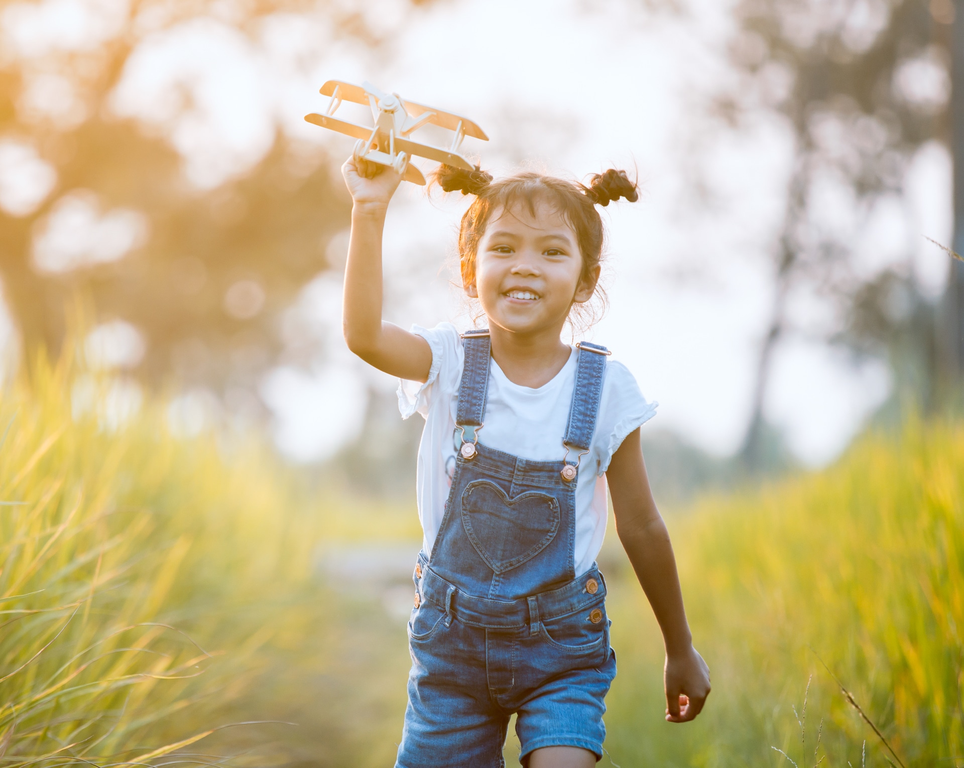 A little girl playing with toy plane