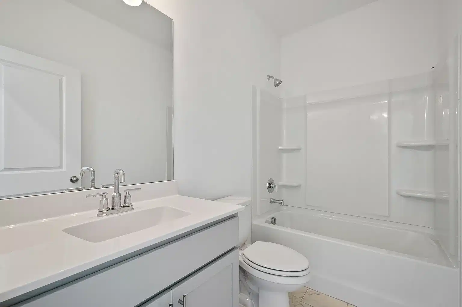 A white walled bathroom in the holston home series by patterson company