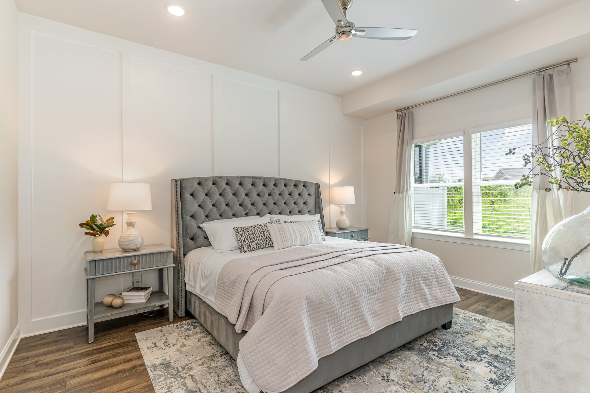 A bedroom with white walls in the cambridge series home by patterson company