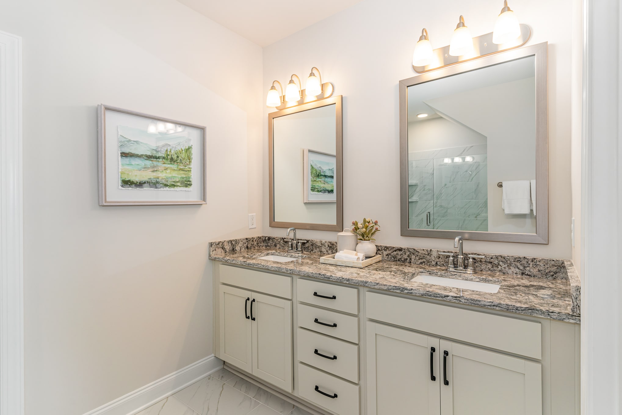 A bathroom with two sinks in the cambridge series home by patterson company