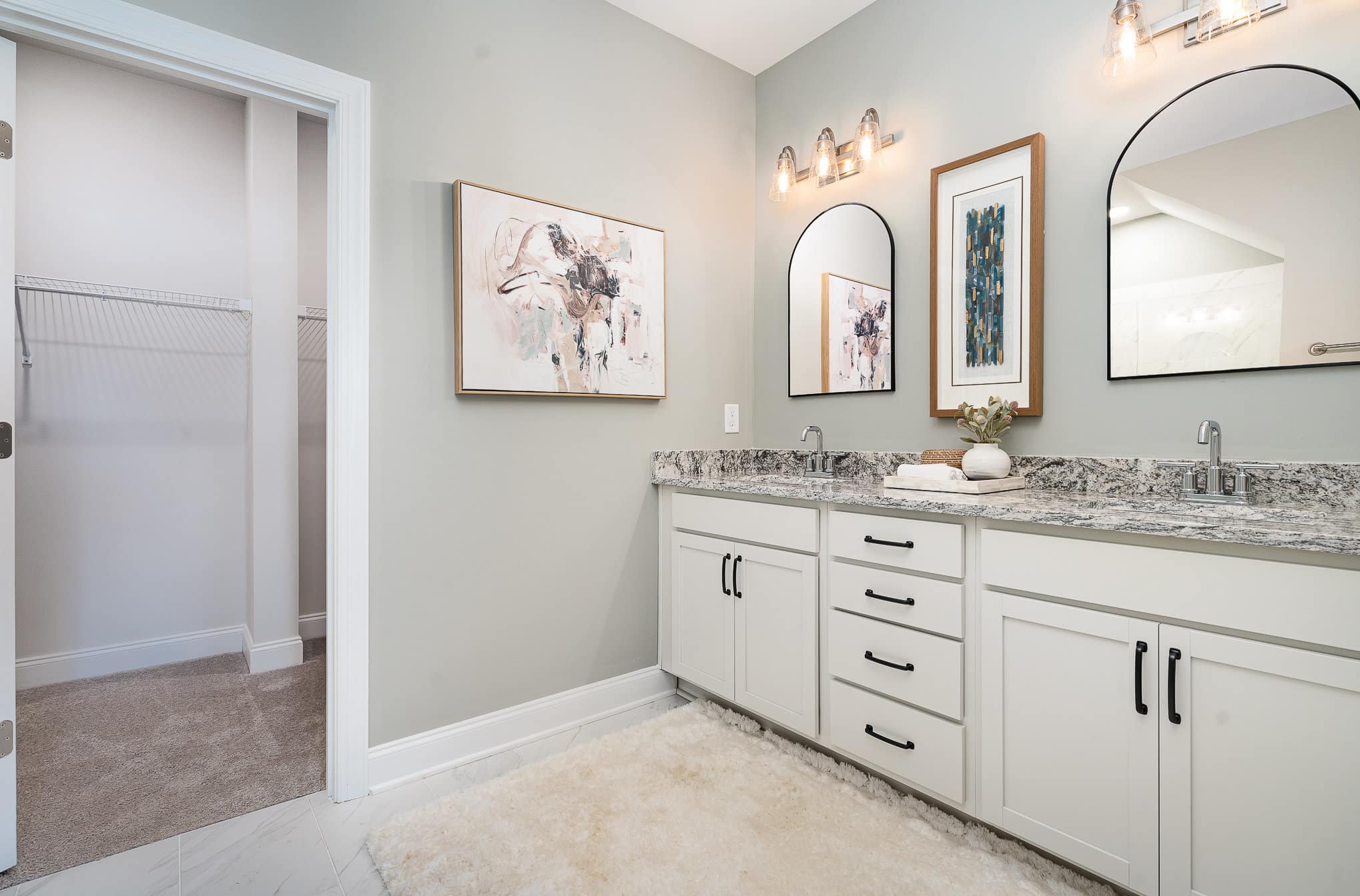 A bathroom with two sinks in the cambridge series home by patterson company