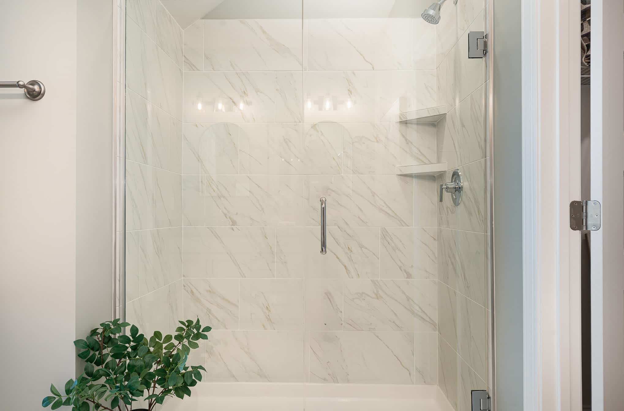 A tiled shower in the cambridge series home by patterson company