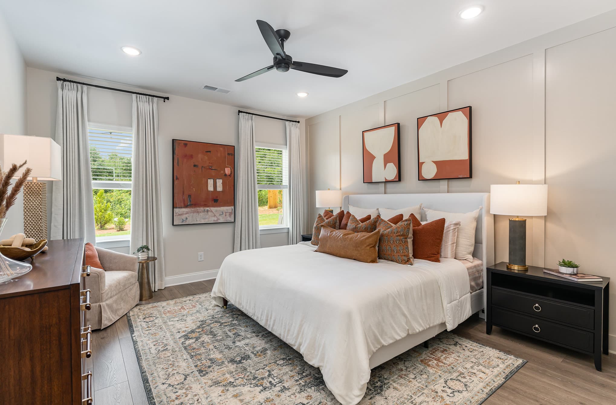 A bedroom with tan walls in a Harpeth series home by Patterson Company