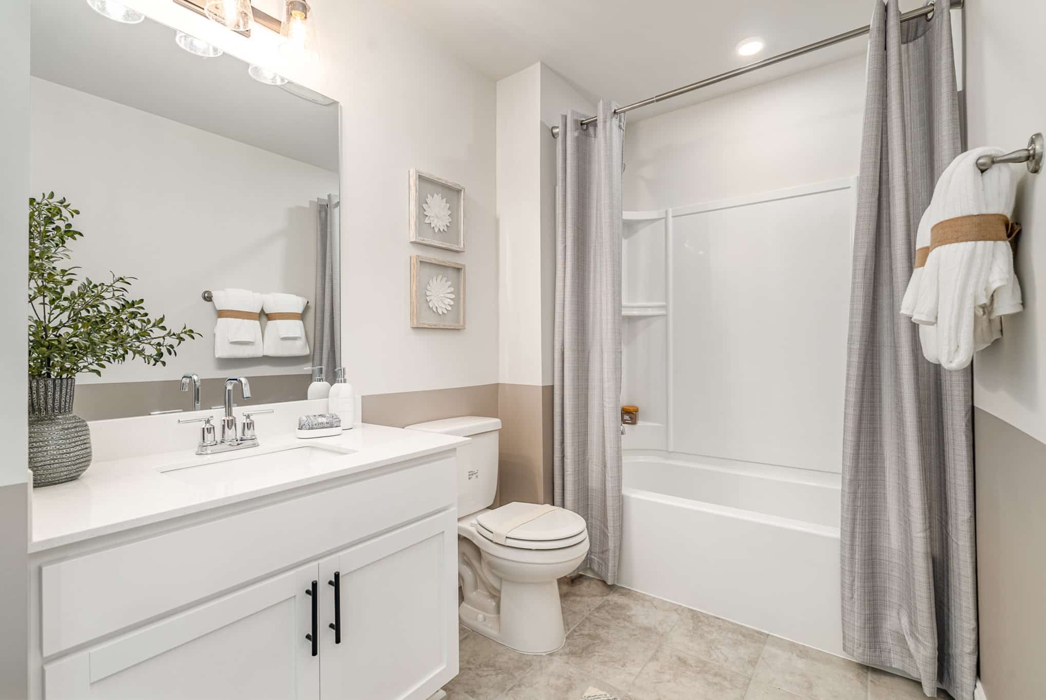 A bathroom with white walls in the Hanover series model home by Patterson Company