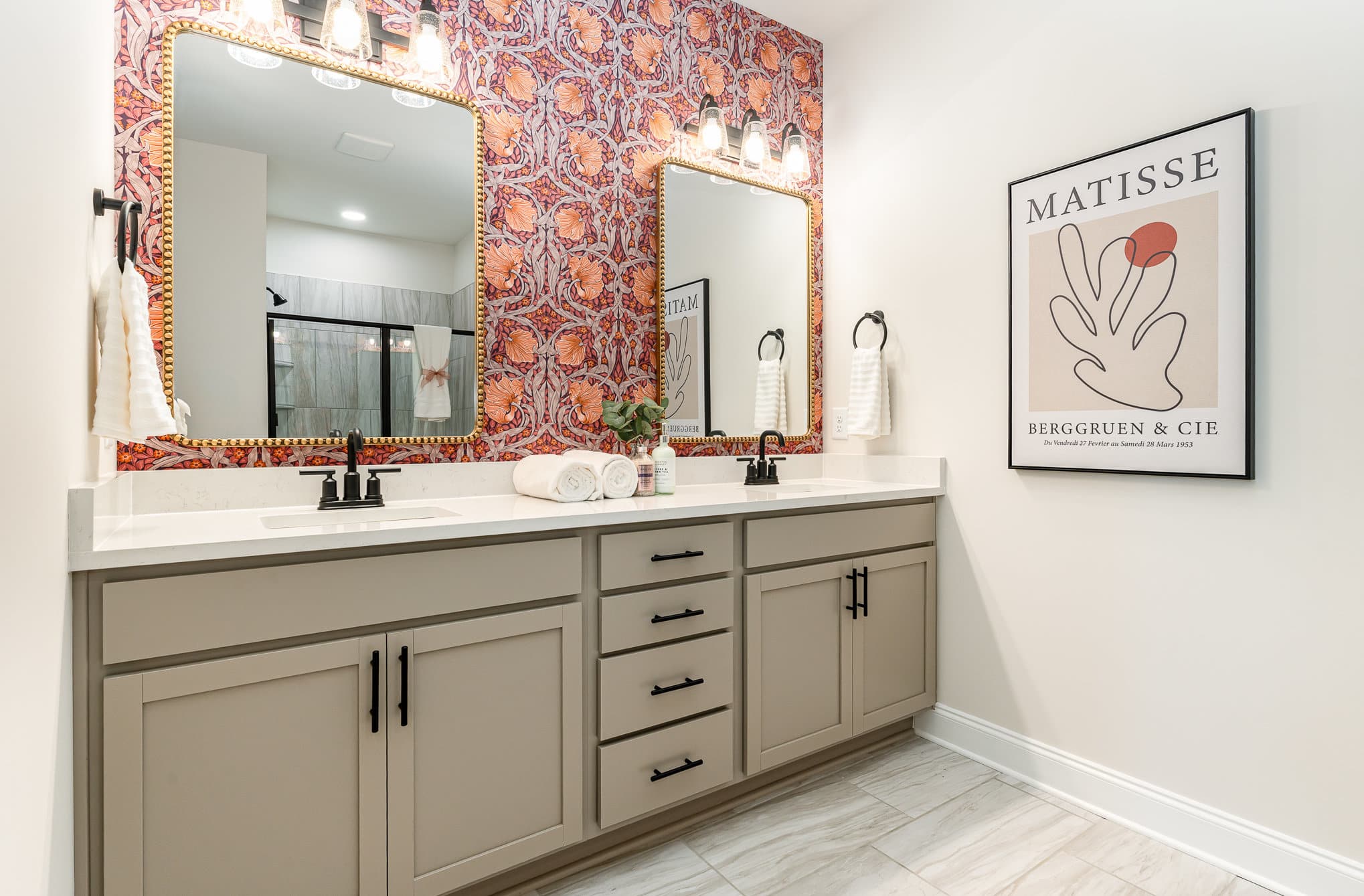 A bathroom with two sinks in a Harpeth series home by Patterson Company