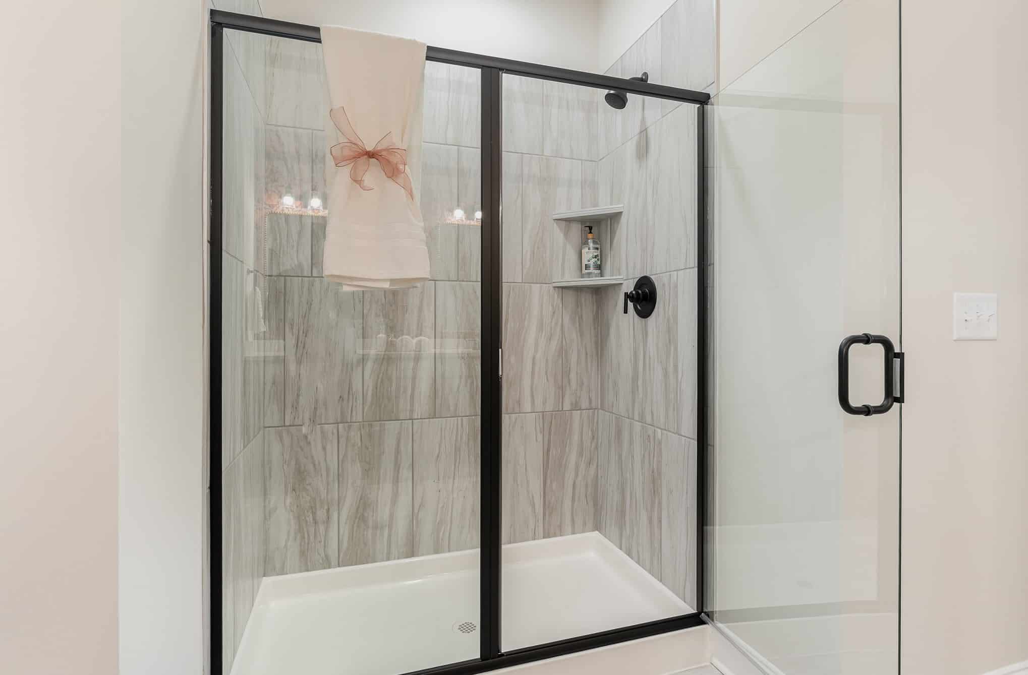 A shower in a Harpeth series home by Patterson Company