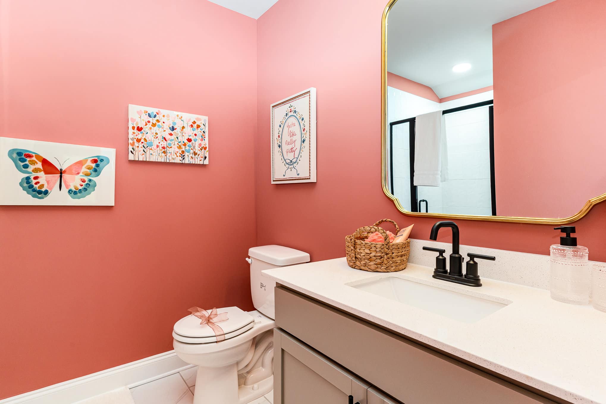 A bathroom with pink walls in a Harpeth series home by Patterson Company